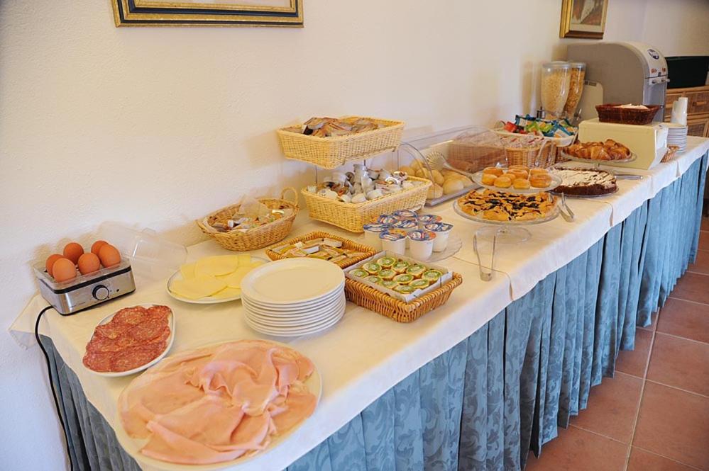 a table with a buffet of food on it at Hotel Alma in Campo nell'Elba