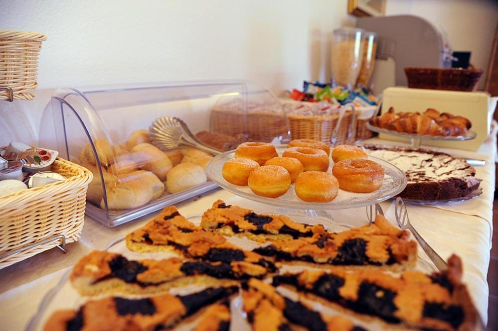 a table topped with plates of pastries and other foods at Hotel Alma in Campo nell'Elba