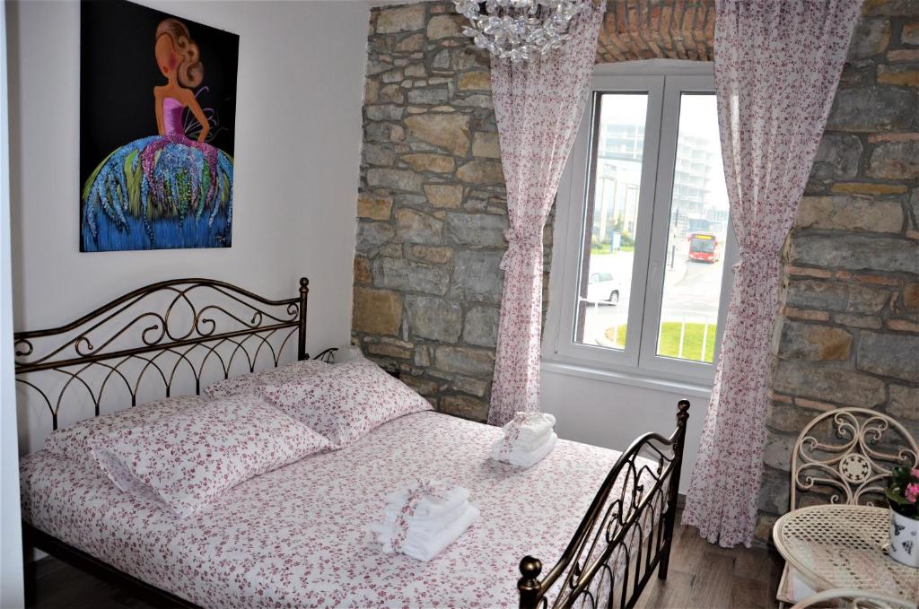een slaapkamer met een bed en een groot raam bij Istrabella Apartment in Koper