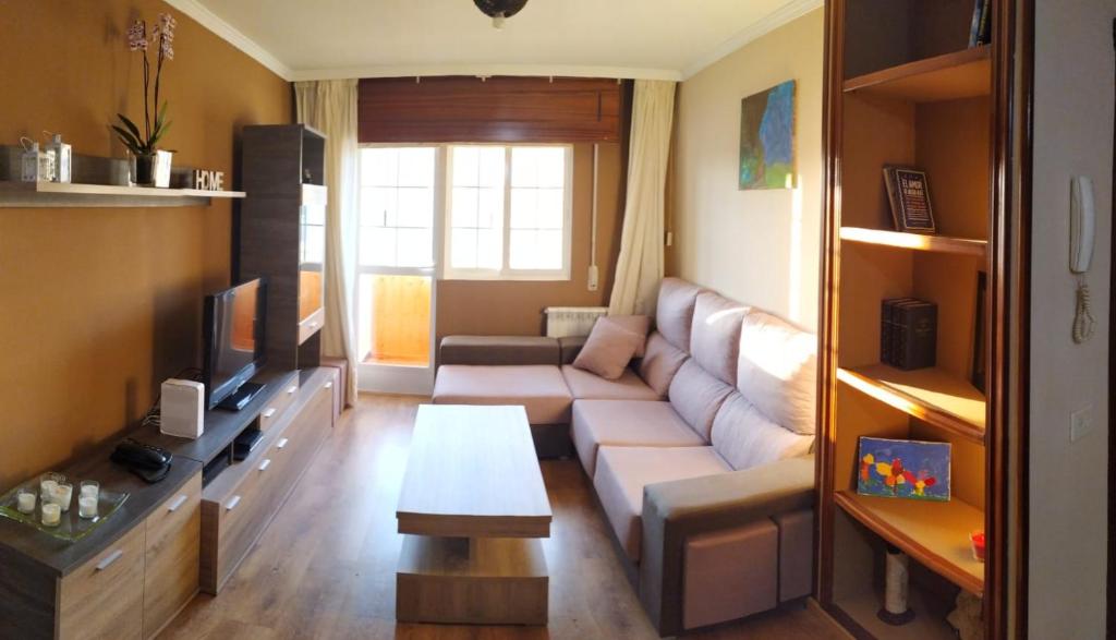 a living room with a couch and a tv at Gonsa 1 in Padrón