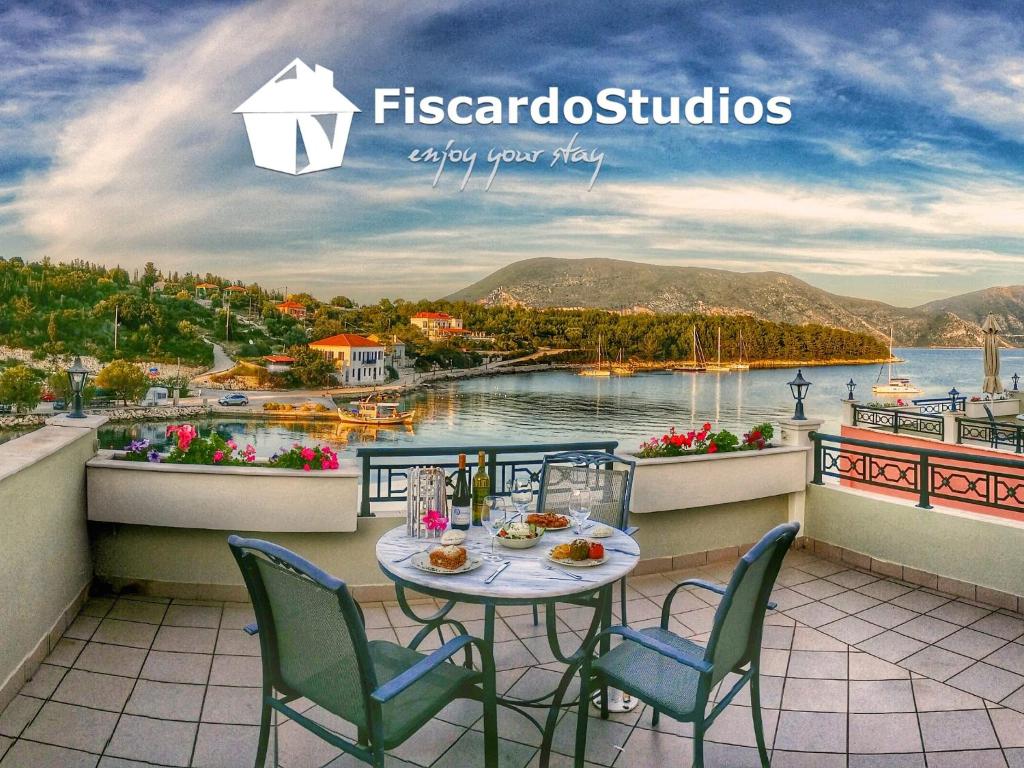 a table on a balcony with a view of the water at FiscardoStudios in Fiskardo