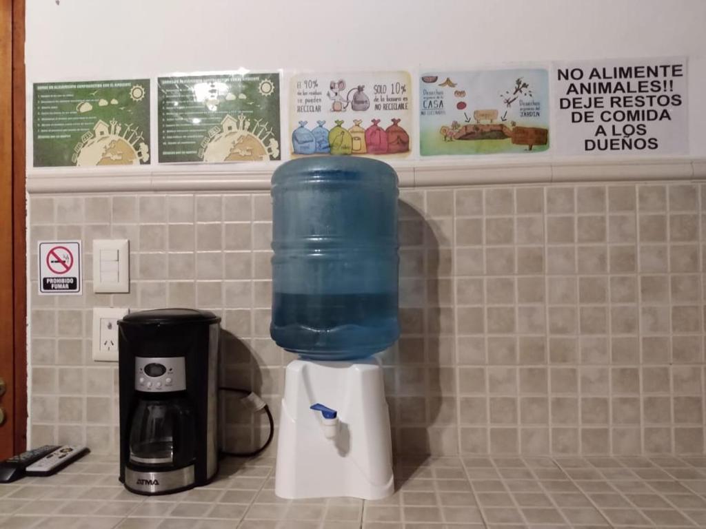 a blue container is sitting on top of a coffee maker at Cabaña Duraznillo in El Cantadero