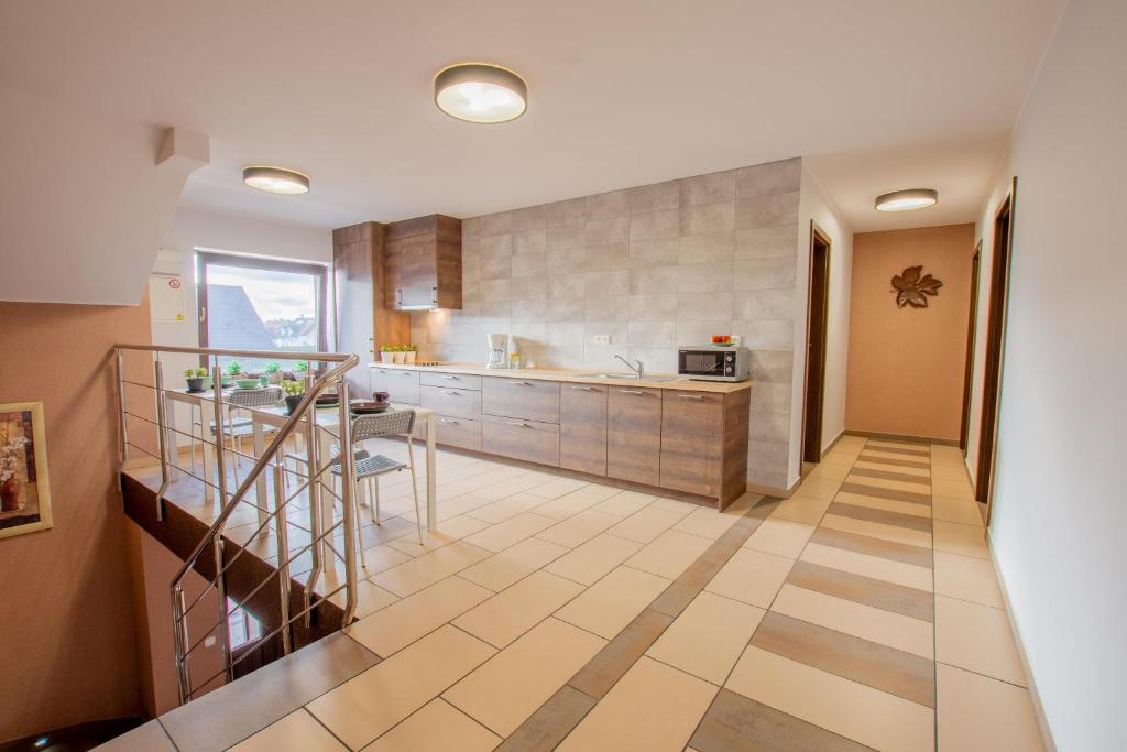 a kitchen with a staircase and a table in it at Villa Sol in Grzybowo