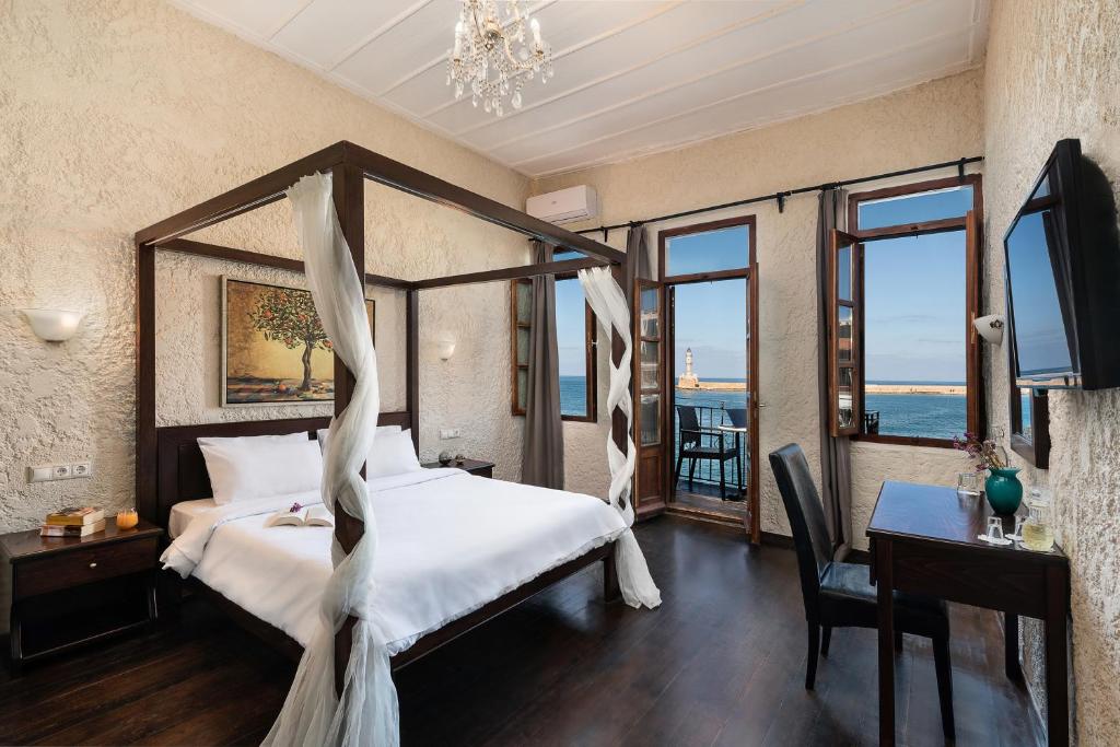 a bedroom with a large bed and a large window at Porto Antico in Chania