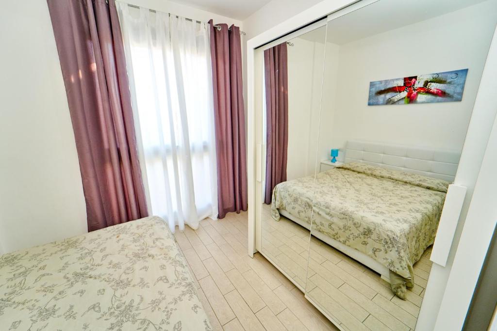 A bed or beds in a room at Affittimoderni Castelsardo Miramare