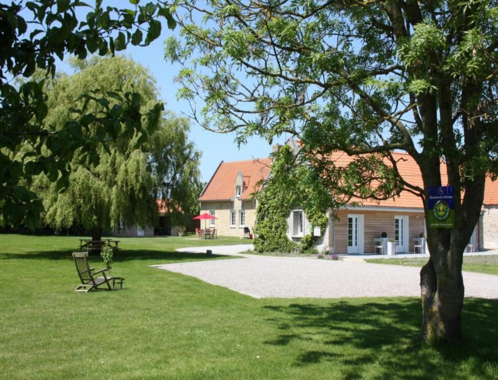 a park with a bench in front of a house at La Haute Muraille in Saint-Folquin