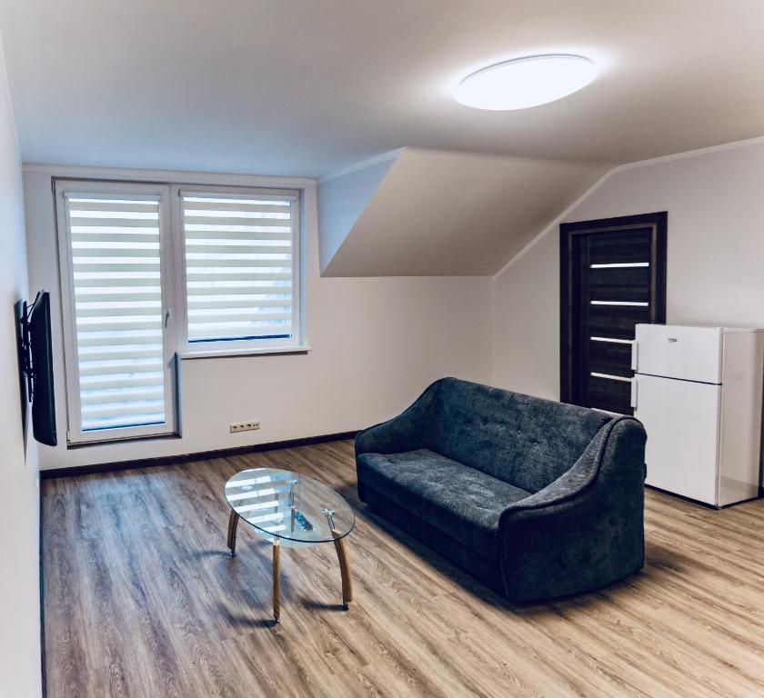 a living room with a couch and a table at Kaunas Castle Apartments - 2 Bedroom Flat in Kaunas