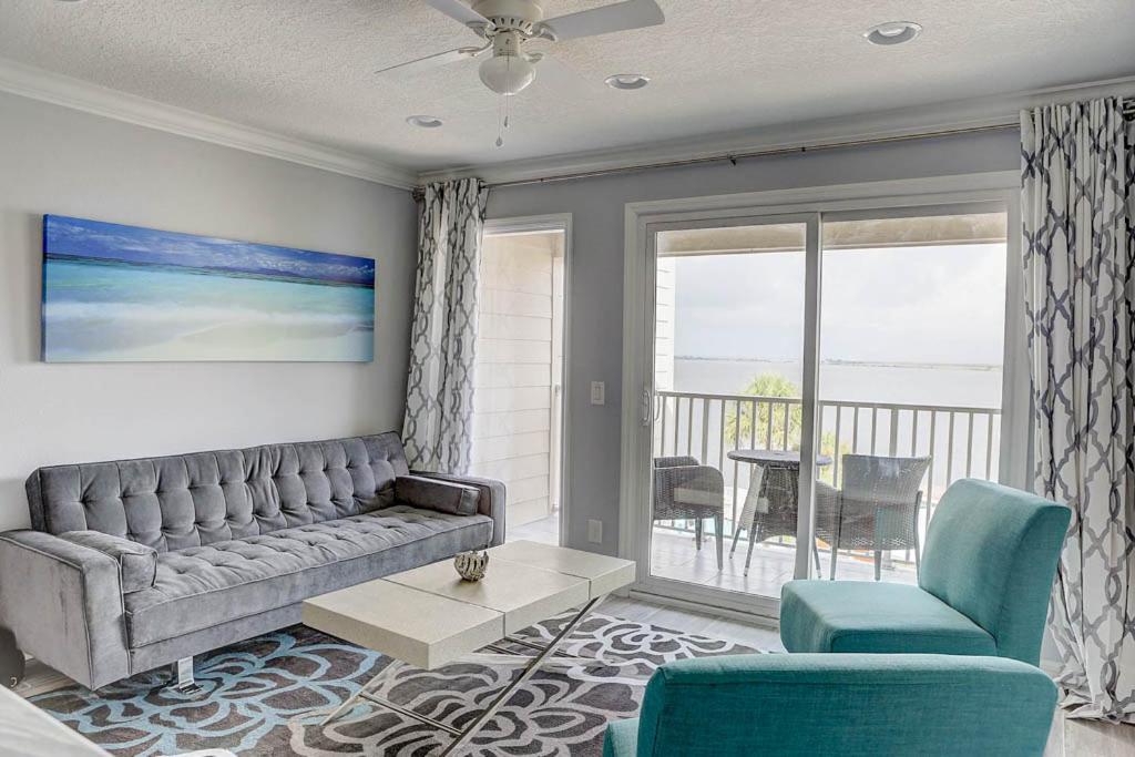 a living room with a couch and chairs and a balcony at La Bella Vita - Luxury Waterfront Condo-Free WIFI-Heated Pool in Tampa
