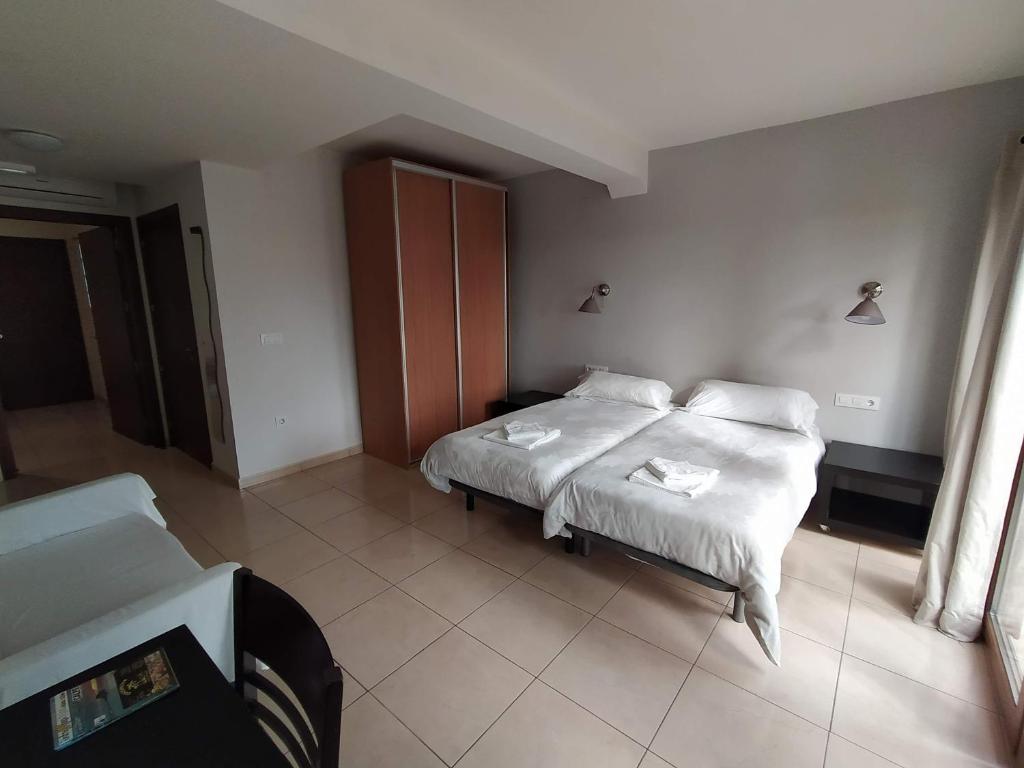 Postel nebo postele na pokoji v ubytování Hostal Gran Sol