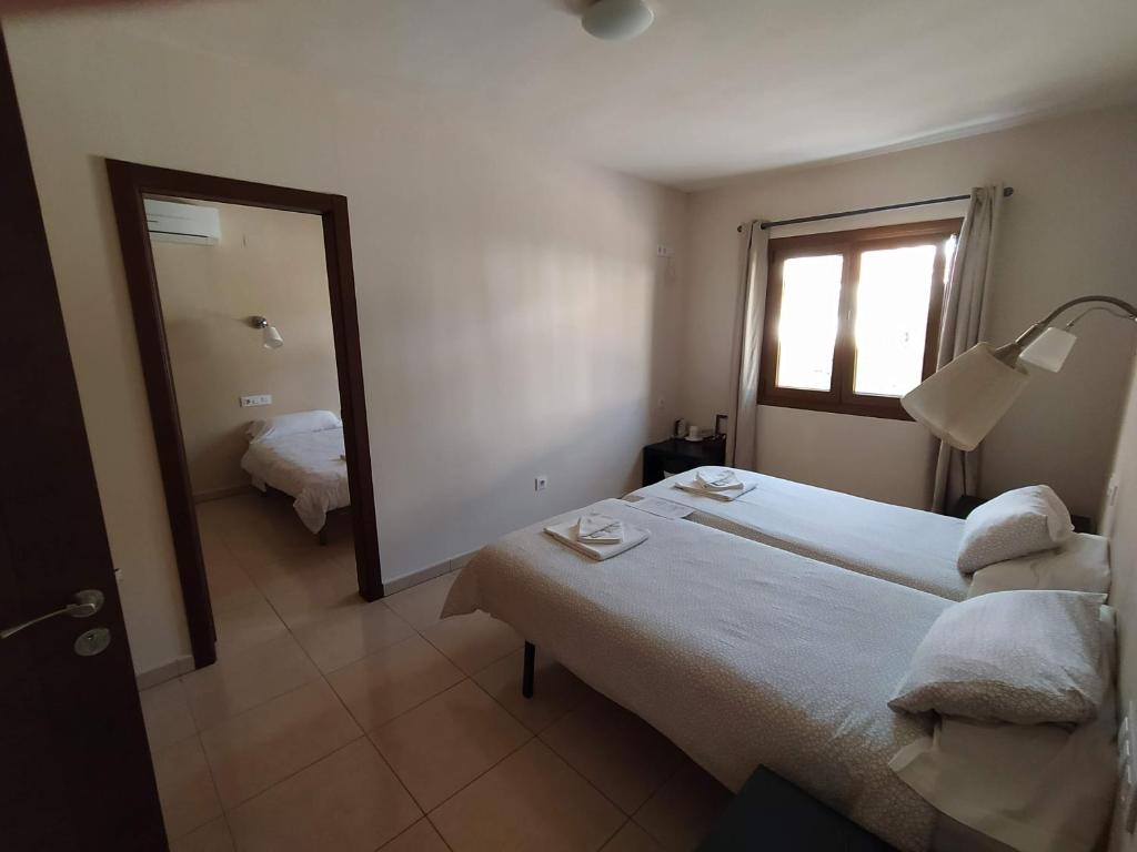 Postel nebo postele na pokoji v ubytování Hostal Gran Sol