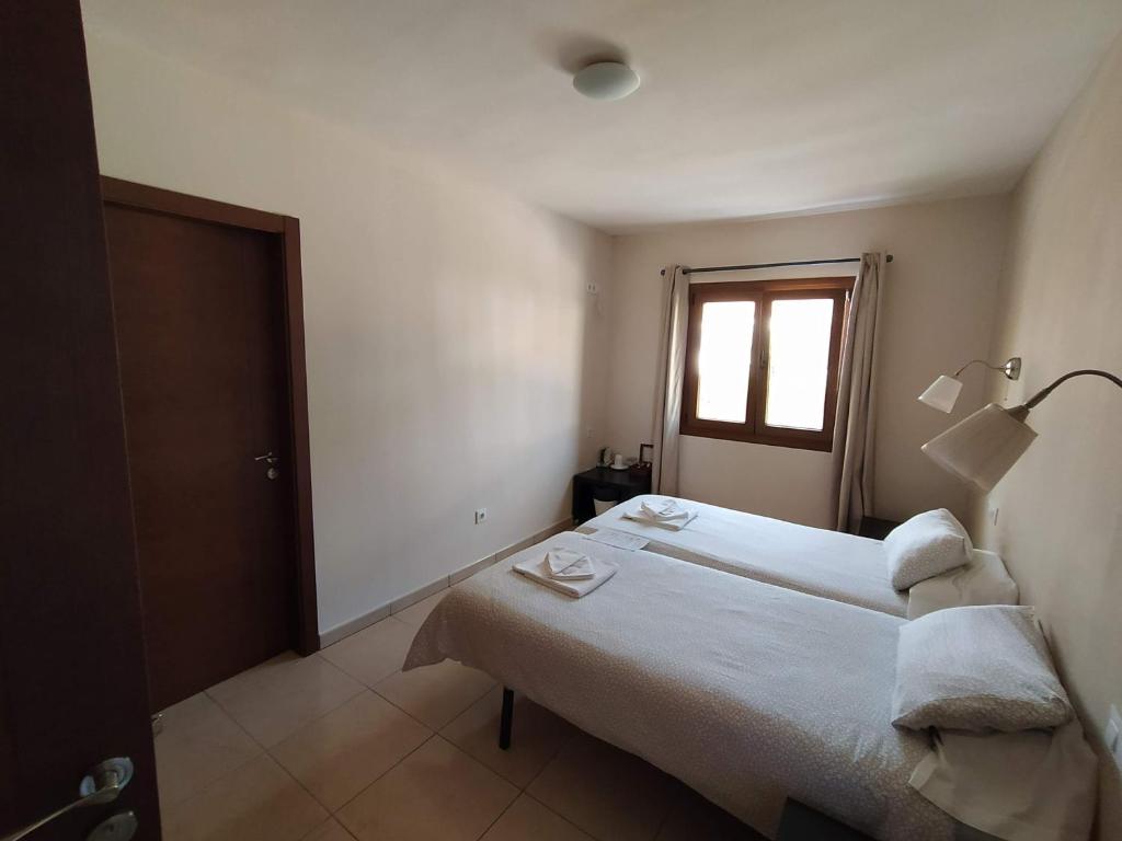 Postel nebo postele na pokoji v ubytování Hostal Gran Sol