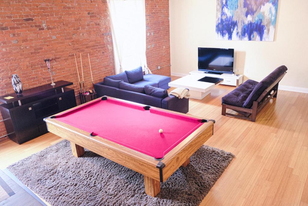 a living room with a pool table in it at Top Floor Loft In Downtown Indianapolis!!! in Indianapolis