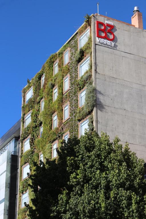 a building with ivy on the side of it at Hotel B3 Virrey in Bogotá