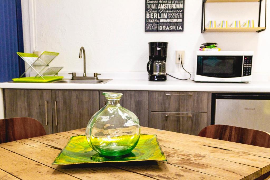 a glass vase sitting on top of a wooden table at Gdl Collection for families in Guadalajara