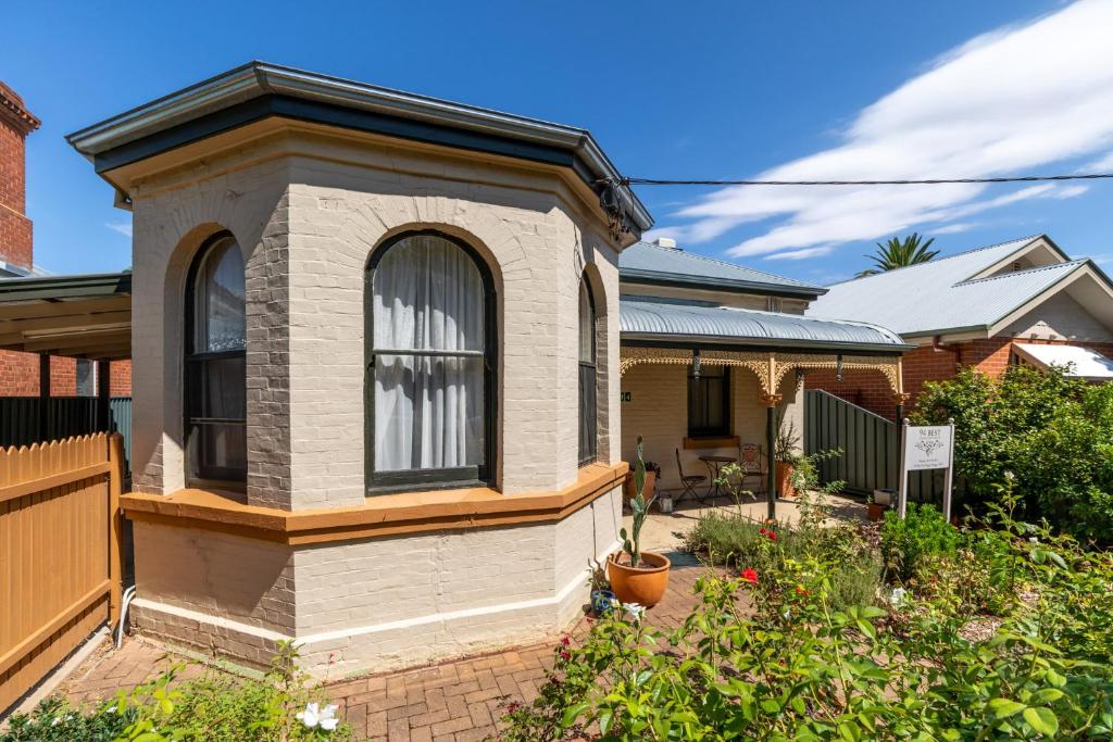 a house with a large window in a yard at 94Best Apartments in Wagga Wagga