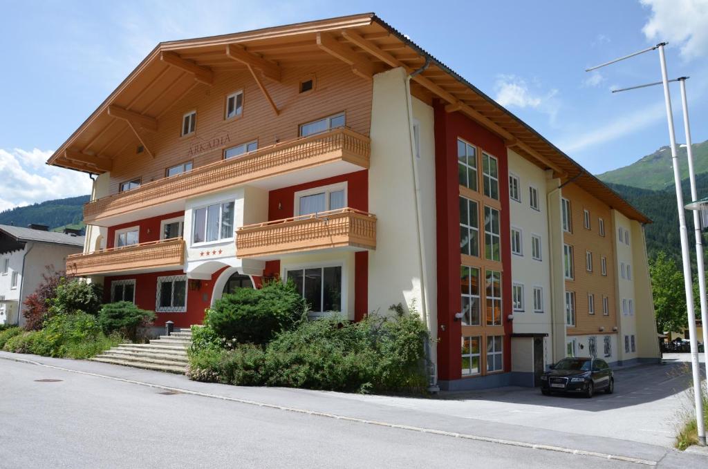 a apartment building with red and white at Arcadia Appartments in Bad Hofgastein