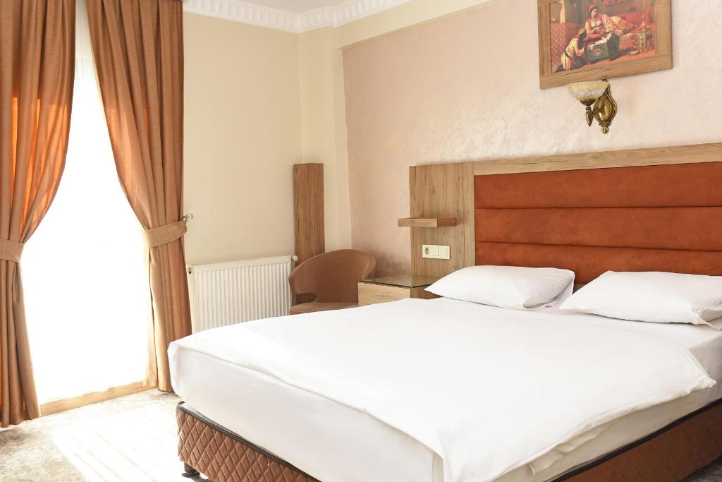 מיטה או מיטות בחדר ב-Hotel Grand Umit