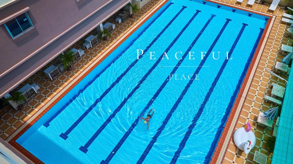 an overhead view of a swimming pool with a person in it at Sivalai Place in Bangkok