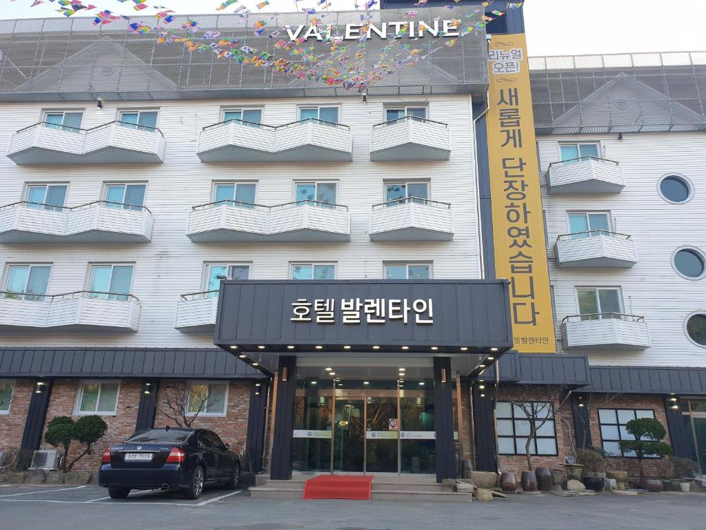 a hotel with a car parked in front of it at Hotel Valentine Gyeongju in Gyeongju