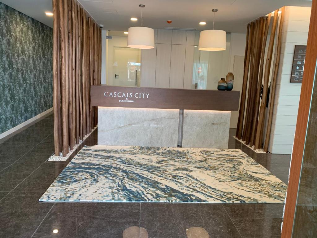 a lobby with a cashfield city sign and a rug at Cascais City & Beach Hotel in Cascais