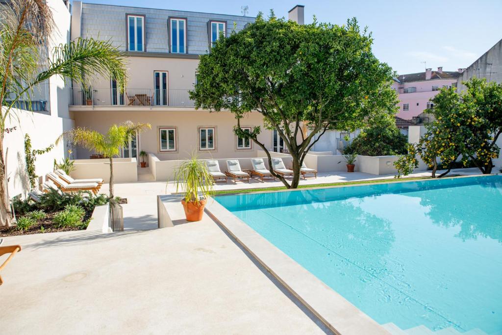 a large swimming pool in front of a building at Casa René - Charming apartments in Almada