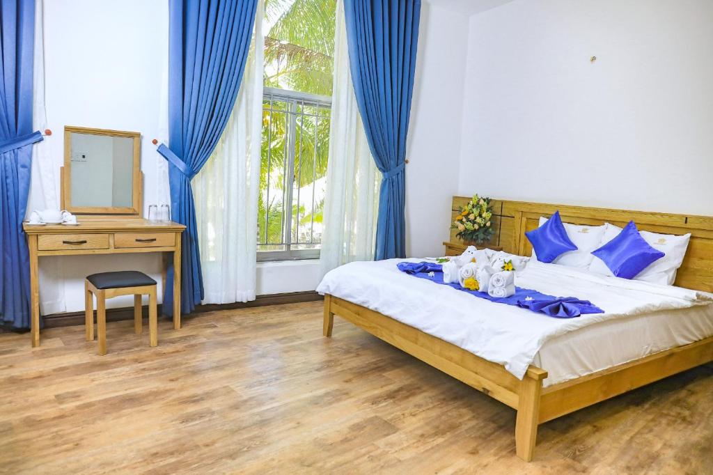 Giường trong phòng chung tại Bàu Mai Resort