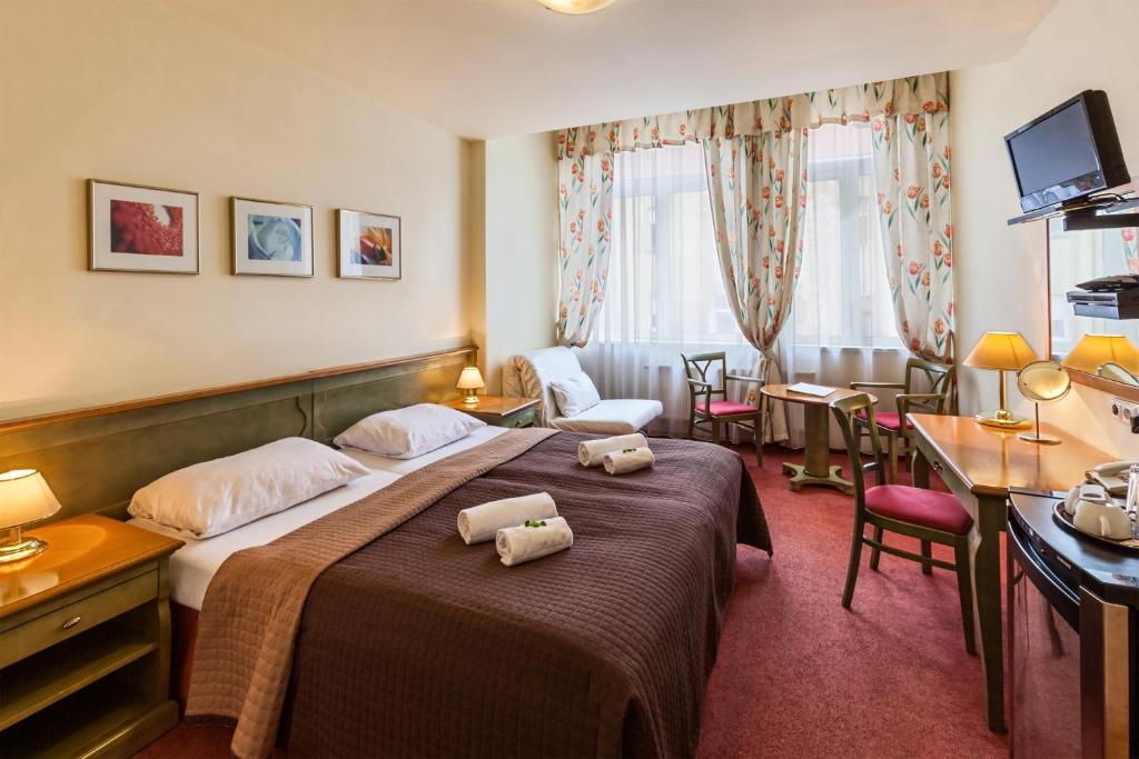 Postel nebo postele na pokoji v ubytování Hotel Augustus et Otto