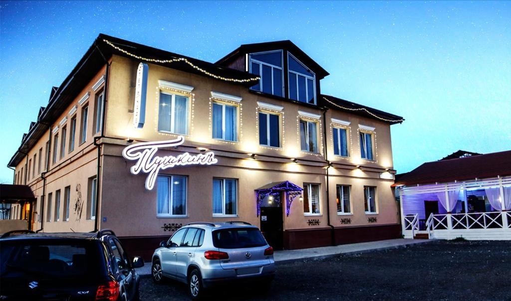 a building with a car parked in front of it at Hotel Pushkin in Pskov