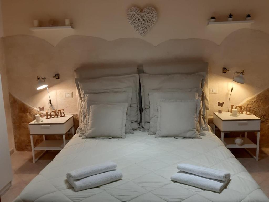 a bedroom with a bed with three towels on it at Nicole House in Bari