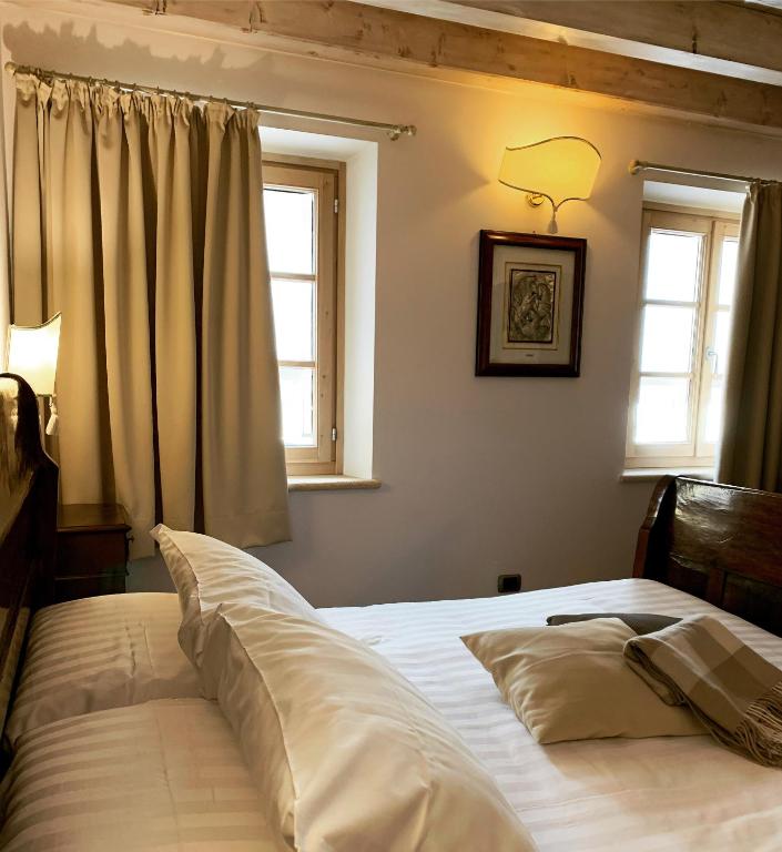Postel nebo postele na pokoji v ubytování Locanda Lo Scudo