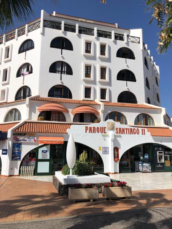 a large white building with a sign on it at Parque Santiago II Tenerife in Arona