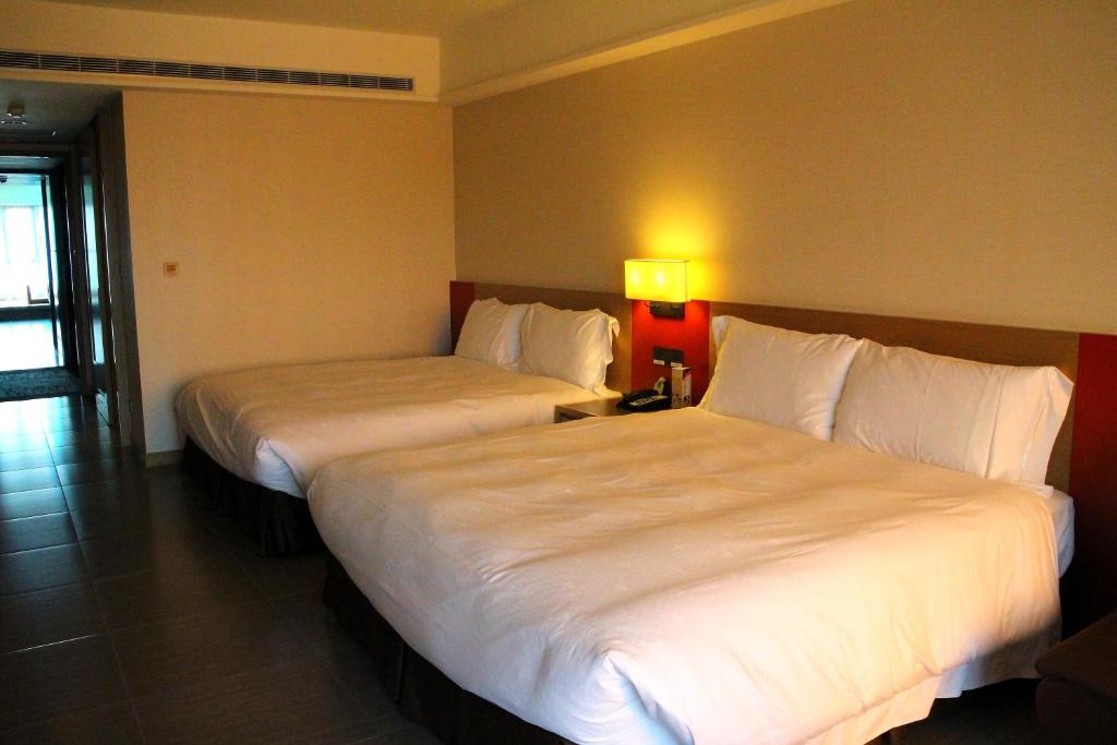Postel nebo postele na pokoji v ubytování Fullon Hotel LihPao Resort