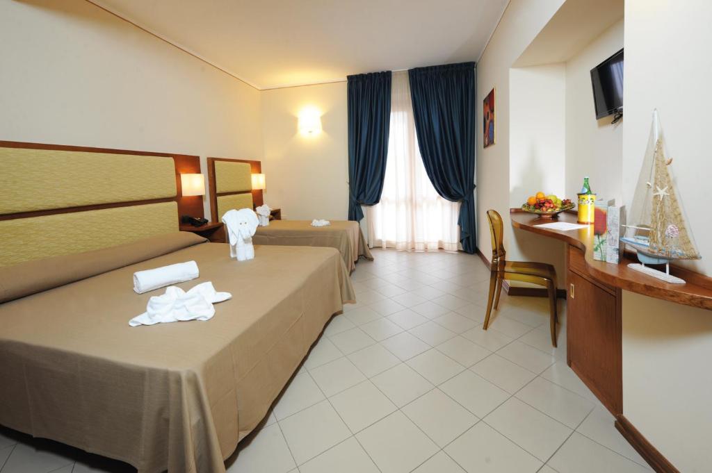 Postel nebo postele na pokoji v ubytování Hotel Tropis
