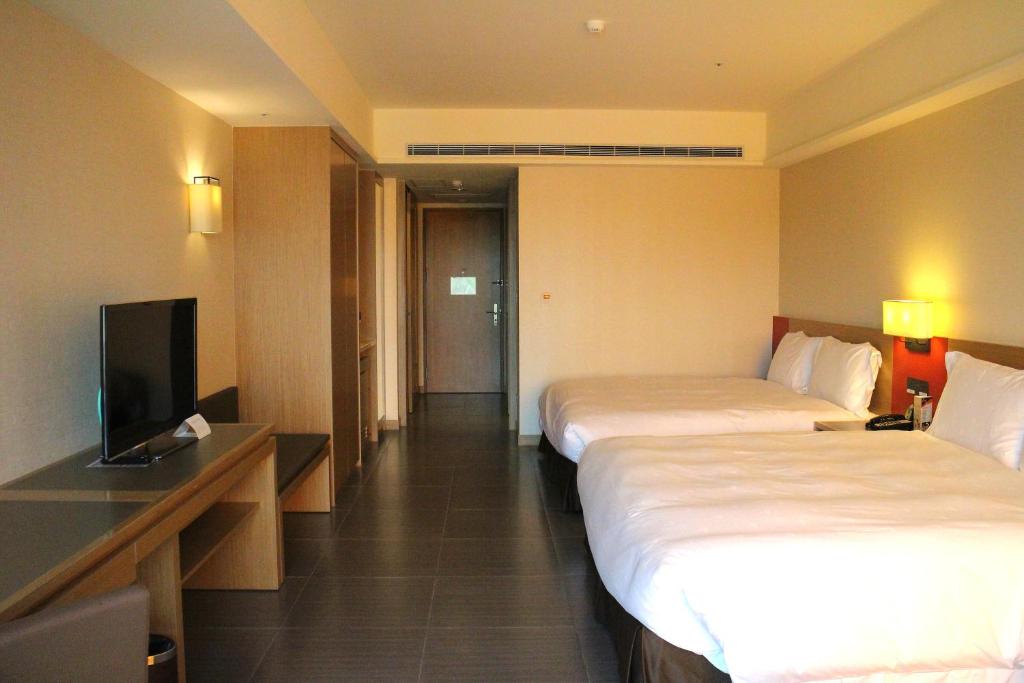 Postel nebo postele na pokoji v ubytování Fullon Hotel LihPao Resort