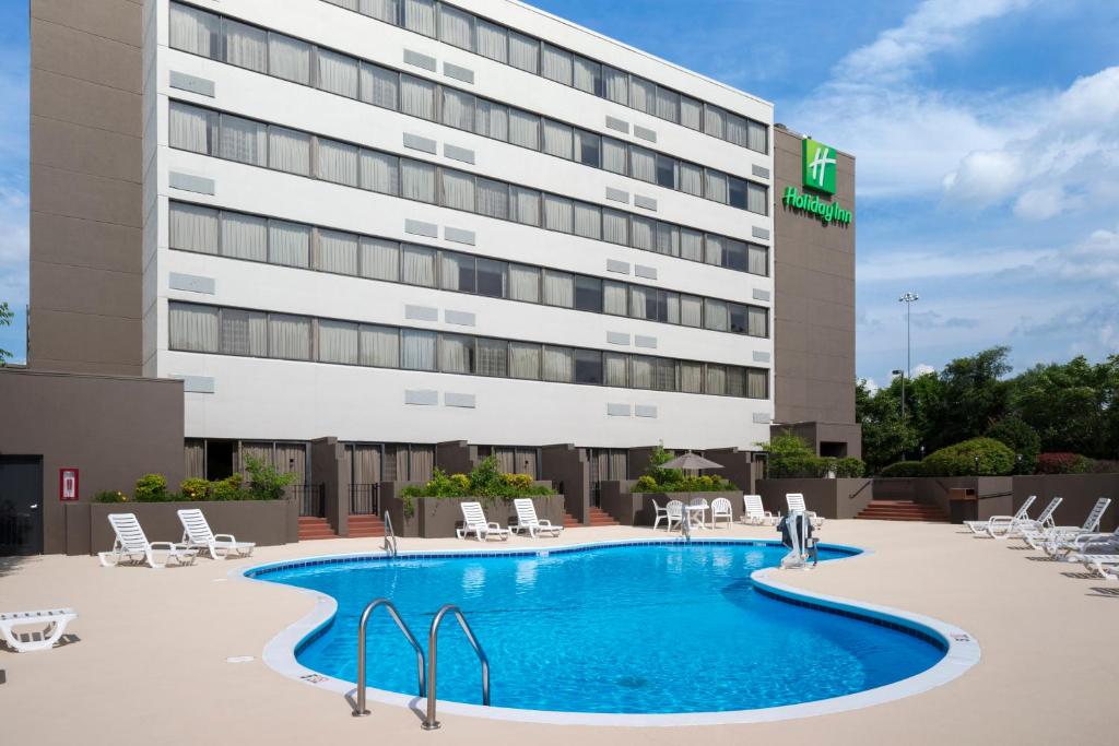 a hotel with a swimming pool in front of a building at Holiday Inn Johnson City, an IHG Hotel in Johnson City