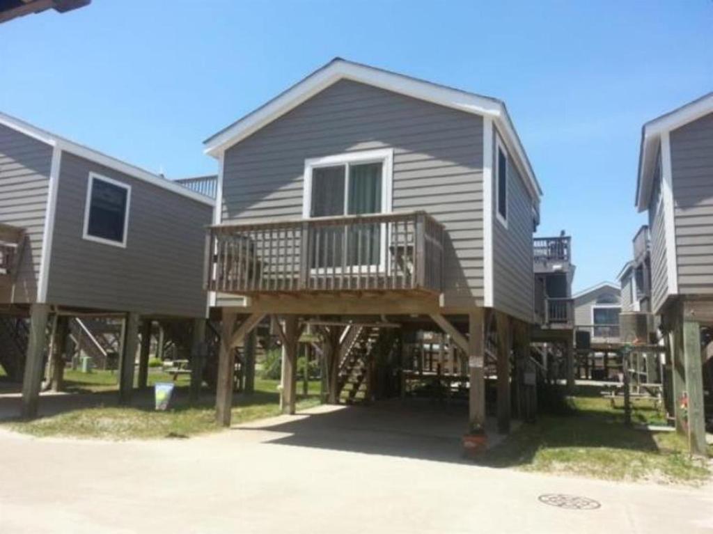 a large house with a deck in the yard at NC 12 56821-23 Condo in Hatteras