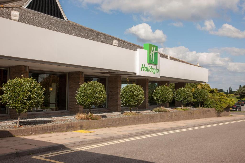 a building with a sign on the side of a street at Holiday Inn Ipswich by IHG in Ipswich