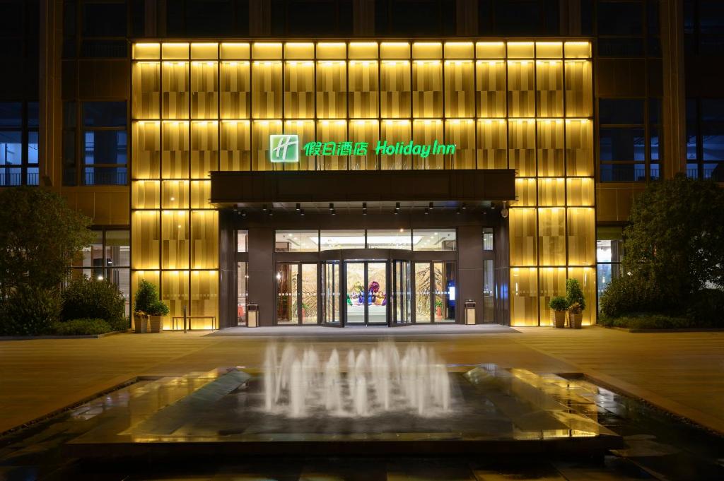 a building with a fountain in front of it at Holiday Inn Kunshan, an IHG Hotel in Kunshan