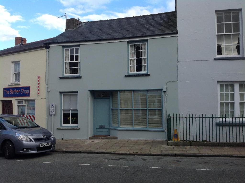 a car parked in front of a white building at 6 Hill Street, Haverfordwest. in Pembrokeshire