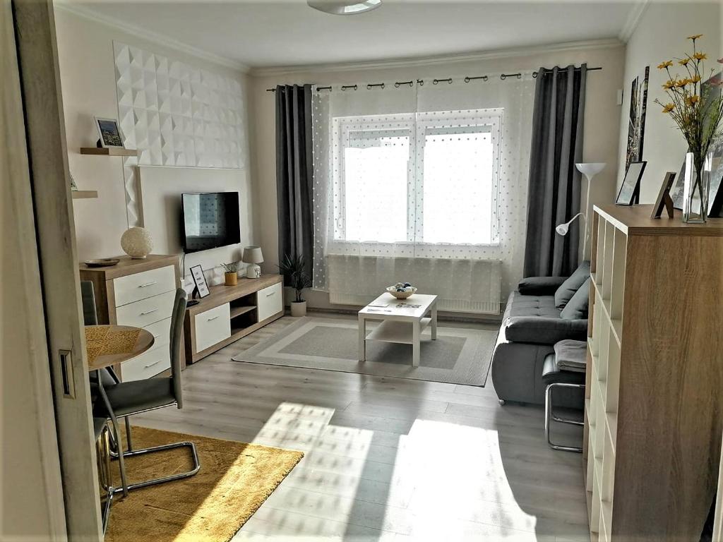 a living room with a couch and a table at Sweet Central Apartment ,in the City center in Eger