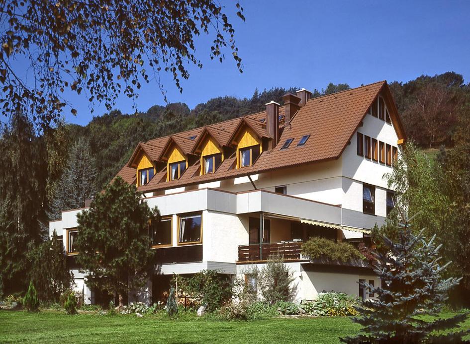 a large white building with a brown roof at Landhotel Reckenberg in Stegen