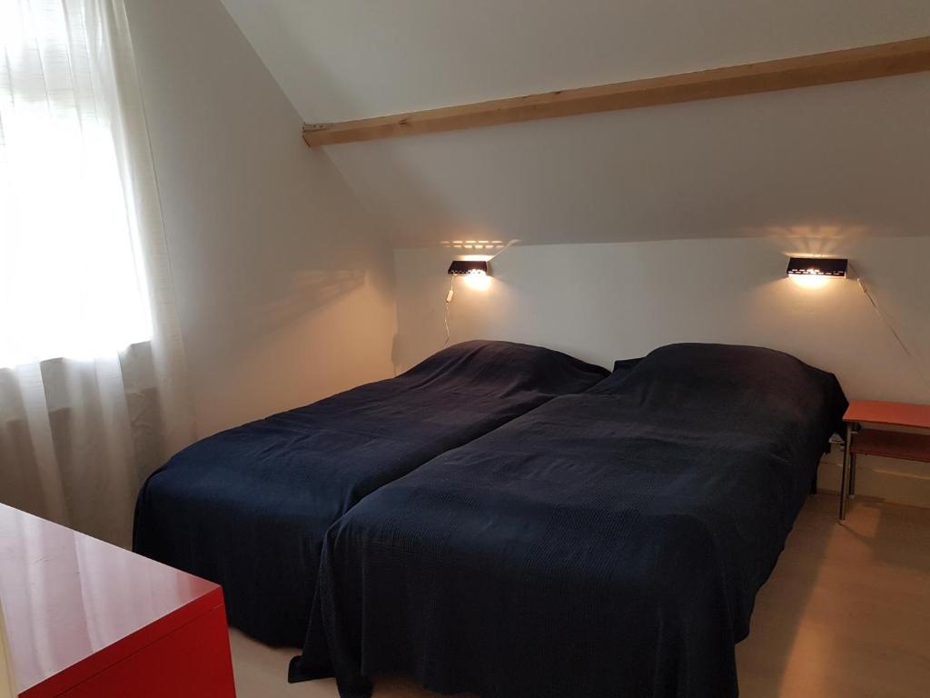 Postel nebo postele na pokoji v ubytování huisje Nieuw Vliet