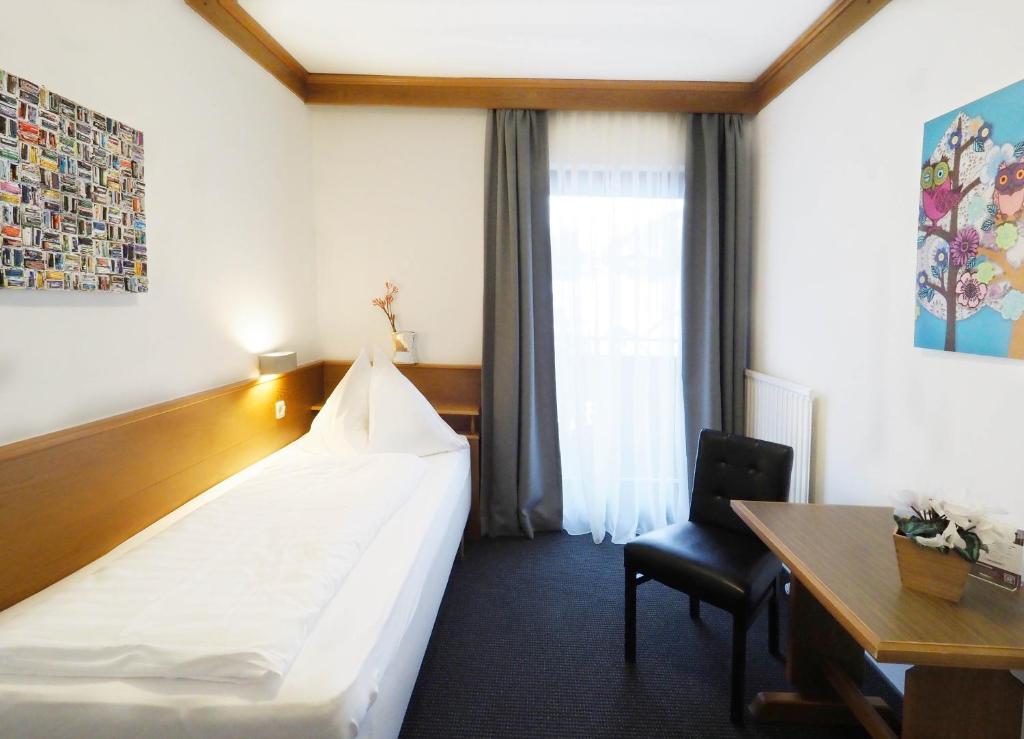 A bed or beds in a room at Pension Anni