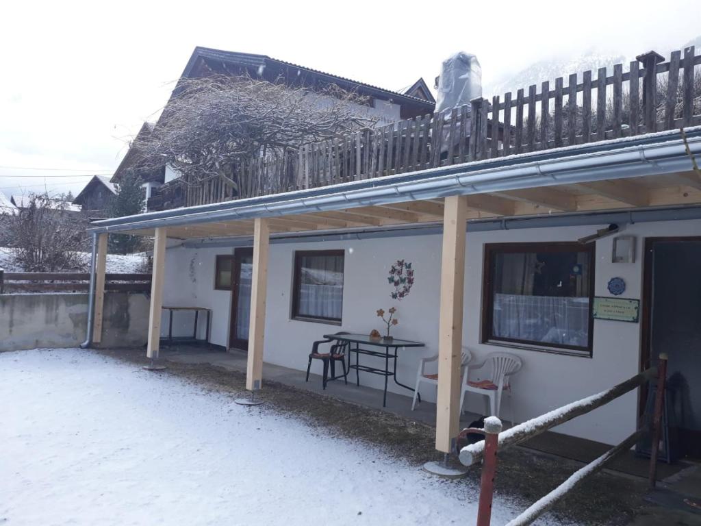 a small white house with a table and a balcony at apartment harmony in Sautens
