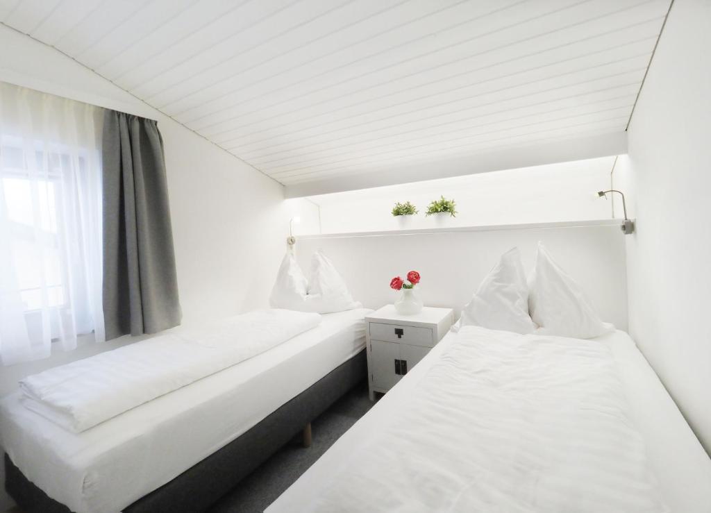 A bed or beds in a room at Pension Anni
