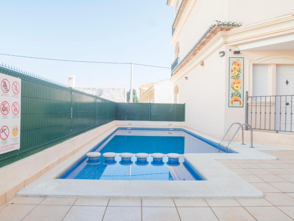 a swimming pool in the backyard of a house at Residencial Los Almendros Playa Romana in Alcossebre