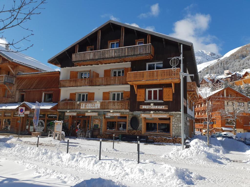 a large building with snow in front of it at cellier 7 in Les Deux Alpes