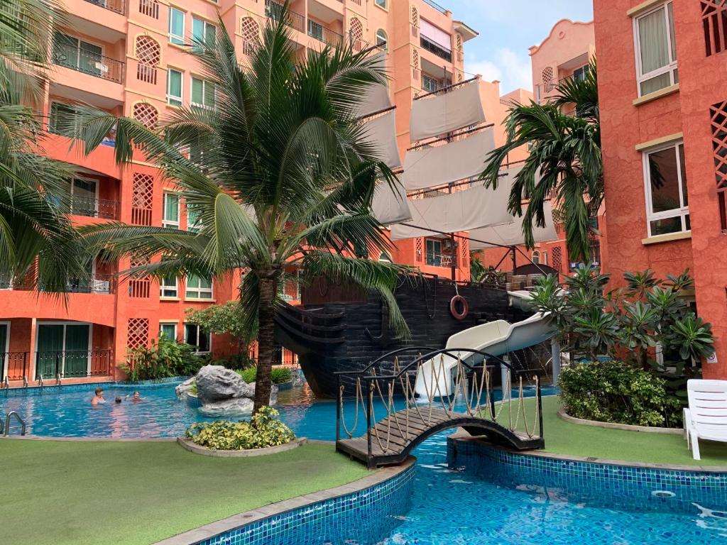 a pool at a hotel with a pirate ship slide at Seven Seas Condo Resort Jomtien in Jomtien Beach