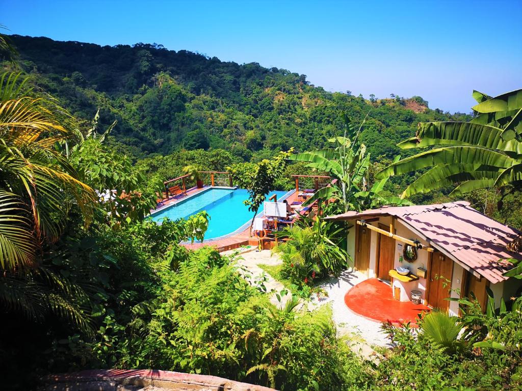 a resort with a swimming pool in the mountains at Masaya Casas Viejas in Minca
