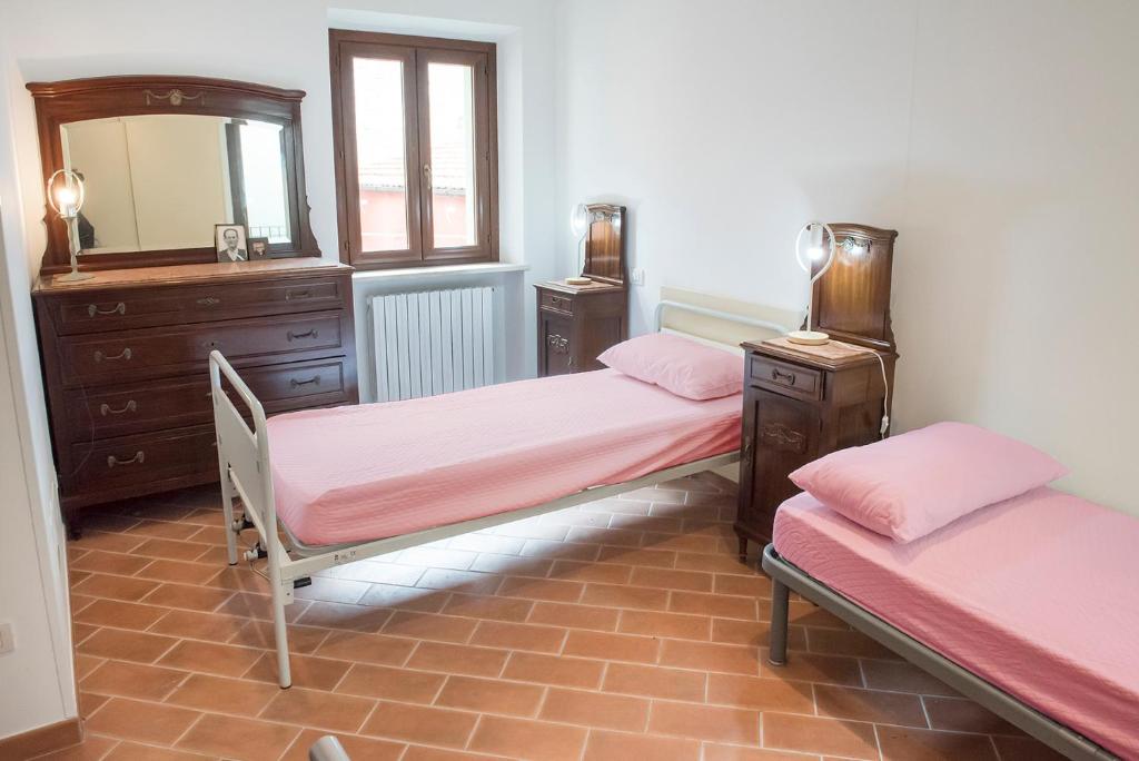 a bedroom with two beds and a mirror and a dresser at N216 - Numana, cielo-terra nei vicoli a 200mt dal mare in Numana